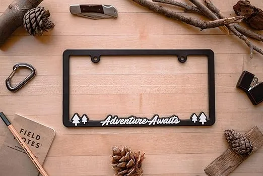 Adventure Awaits License Plate Frame Holder for US/CAN by Spiffy | Cool Exterior Accessory Matte Finish with Glossy Lettering | Weatherproof | Great Gift | Off-Road RV or Camper Van | Made in The USA